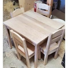 a table and chairs made out of wood in a room with unfinished furniture on the floor