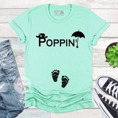 a t - shirt that says poppin with footprints and an umbrella