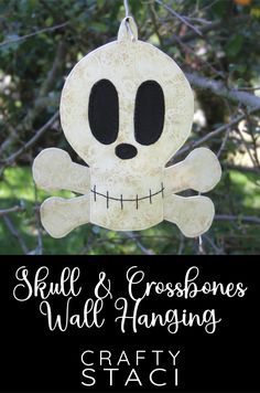 a skull and crossbones hanging from a tree with the words crafty staci