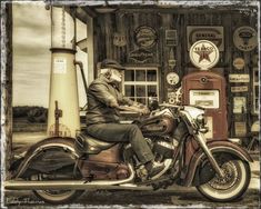 a man is sitting on his motorcycle in front of a gas station with an old fashioned pump