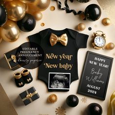 a new year baby announcement with gold and black decorations, gifts, and other items