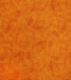 an orange background with some brown stains on it