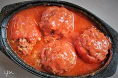 meatballs covered in tomato sauce in a cast iron skillet