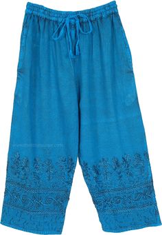 These Capri pants are made of soft rayon fabric, featuring intricate floral embroidery along the lower hem, adding a touch of bohemian elegance.  The pants have a relaxed, wide-leg fit with an elastic waistband and an adjustable drawstring for a comfortable and customizable fit. #tlb #SplitSkirtsPants #Pocket #Summerpants Bohemian Blue Embroidered Pants, Blue Hippie Pants With Pockets, Bohemian Blue Ankle-length Bottoms, Blue Hippie Cotton Pants, Turquoise Pants, Bohemian Full-length Blue Harem Pants, Flowy Wide Leg Pants, Gaucho Pants, Turquoise Blue Color