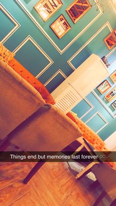 a living room with blue walls and pictures on the wall above it that says things and but memories last forever