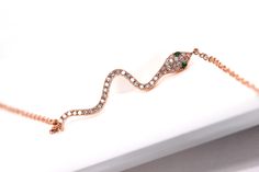 Beautiful, High Quality 14k Dainty Diamond Snake Bracelet in 14k Solid YELLOW GOLD Genuine Diamonds Adjustable Sizing, the bracelet can be extended between 6-7 inches using the links to choose your perfect fit. See pics of the adjustable links Diamonds are set on top of the curvy snake body. The snake eyes are (2) Natural Tsavorite Stones. The Diamond Quality: Diamond Color: F Diamond Clarity: SI1 Diamond Cut: Rounds Diamond Cut: Excellent There are a total of (41) Round Cut Diamonds at the diam Elegant Snake-shaped Chain Bracelet Gift, Elegant Flexible Snake-shaped Bracelet, Rose Gold Bracelets With Adjustable Chain For Party, Rose Gold Adjustable Chain Bracelet For Party, Flexible Rose Gold Bracelet In Fine Jewelry Style, Flexible Rose Gold Bracelet Fine Jewelry, Elegant Gold Snake-shaped Bracelet, Elegant Gold Snake Shape Bracelet, Rose Gold Diamond Bracelet As Gift