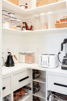 an organized pantry with coffee maker, toaster, and other items on the shelves