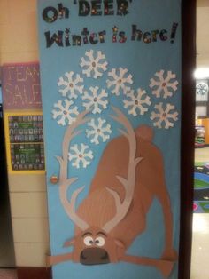 a door decorated to look like a reindeer with snowflakes on it and the words deer winter is here