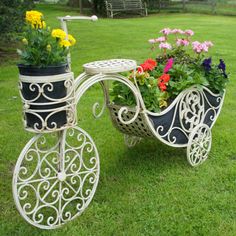 a white bicycle with flowers in the basket