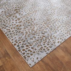 an animal print rug on the floor in a room with wooden floors and hard wood floors