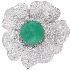 This stunning platinum brooch features a natural cabochon cut emerald weighing 33.93 carats set in a flower motif brooch which has 340 bead set round brilliant cut diamonds with an estimated total weight of 15 carats. This brooch was owned by the famous Greek actress Madame Kyveli, who at one time was married to George Papandreou, Prime Minister of Greece. Metal Type: Platinum Diamond Flower Brooch, Diamond Bracelet Design, Mint Candy, Van Cleef And Arpels, Sparkle Necklace, Purple Jewelry, Emerald City, Green Jewelry, Diamond Brooch