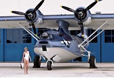 a woman standing in front of an airplane