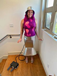 a woman in a costume standing on the floor with a hose attached to her head