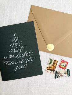 a christmas card and envelope with stamps on the inside, next to an envelope that says it's not possible to write this year