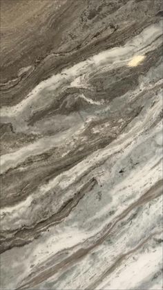 a marble counter top with brown and white colors