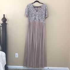 This Maya Deluxe Blush Maxi Dress Is A Beautiful Dress Perfect For A Wedding. Empire Waist.Vneck. Sequin Top. Short Sleeves. Tulle Bottom With Lining. New With Tags. Size 12. 100% Polyester. Length: 60in. Bust: 18in. Arm Length: 8in. Silver Spring Wedding Maxi Dress, Spring Wedding Silver Maxi Dress, Elegant Silver Bridesmaid Dress, Glamorous V-neck Dress For Mother Of The Bride, Silver Spring Wedding Dress, Spring Silver Wedding Dresses, Spring Wedding Silver Dress, Short Sleeve Sequined Maxi Dress For Wedding, Glamorous Short Sleeve Maxi Dress For Wedding