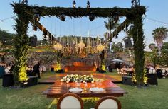 an outdoor wedding setup with wooden tables and chairs