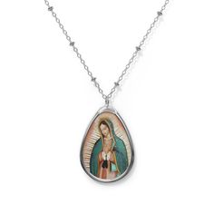 Add a custom touch to what you're wearing with this necklace showing the beautiful painting of Our Lady of Guadalupe  The pendant and its chain are made with robust brass material for dazzling looks that are long-lasting. The print panel is made with aluminum while the pendant itself comes in a unique shape of an ellipse. .: Brass pendant and necklace chain .: Ellipse-shaped pendant .: White aluminum print surface .: Lobster clasp closure Spiritual Oval Our Lady Of Guadalupe Necklace, Spiritual Oval Necklace Featuring Our Lady Of Guadalupe, Oval Our Lady Of Guadalupe Jewelry Gift, Oval Our Lady Of Guadalupe Necklace For Gift, Oval Our Lady Of Guadalupe Necklace Gift, Silver Our Lady Of Guadalupe Necklace, Oval Virgin Mary Jewelry Gift, Spiritual Our Lady Of Guadalupe Jewelry Gift, Virgin Mary Pendant Necklace As Gift