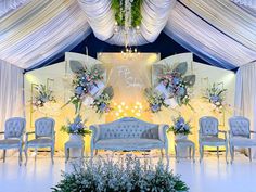 a wedding stage set up with chairs and couches