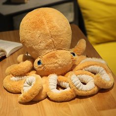 an octopus stuffed animal sitting on top of a wooden table