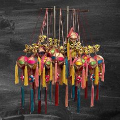 a group of colorful masks hanging from strings