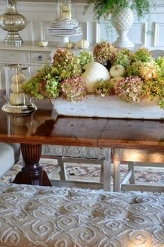 an orange table with flowers and candles on it