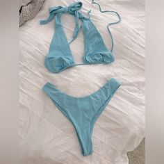 Color Truest To First Photo Bikini With Two Tops Options Beautiful Baby Blue Bright And Cute! Adjustable Ties High Waist Cheeky Bottoms Brand New Without Tags Out From Under Brand Top Size Large - Adjustable Can Fit Various Busts Second Top With Structured Bust Size Medium Also Adjustable Straps Bottoms Size Medium- Can Also Fit Small I Think Listing As Medium Size Bikini The Top Alone Was $50 The Second Top Is A Slightly Bolder Blue, You Could Even Pair With Just White Bikini Bottoms Too. Blue T-back Summer Swimwear, Blue Halter Top For Spring Beach Party, Blue T-back Halter Top For Poolside, Blue Halter Top For Poolside Spring Season, Spring Blue Halter Top For Poolside, Blue Halter Top For Summer Beach Party, Blue Beachwear Halter Top For Vacation, Blue Halter Top For Beach Vacation, Blue Summer Halter Top For Beachwear