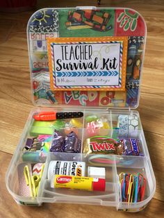 a plastic container filled with school supplies on top of a wooden floor