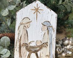 a nativity scene is displayed in front of christmas decorations