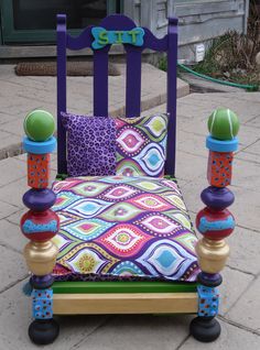 a brightly colored bed sitting on top of a sidewalk