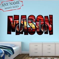 a bedroom with a wall decal that has the name mason on it in red and yellow