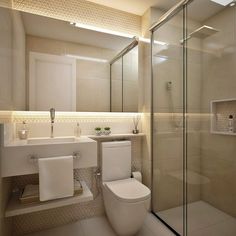 a bathroom with a toilet, sink and shower stall