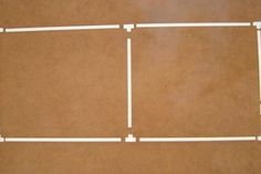 four pieces of white wire sitting on top of a brown floor