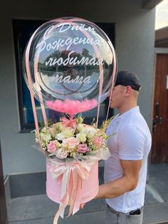 a man is holding a large balloon with flowers in it and the words dream happens, no ordinary name