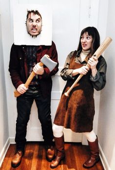 two people in costumes holding baseball bats and a paper cutout of a man with a beard