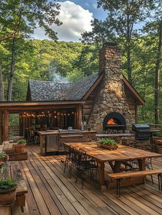 a wooden deck with an outdoor fireplace and grill in the middle, surrounded by trees