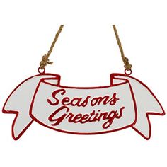 an ornament with the words seasons greetings hanging from a rope on a white background