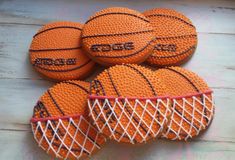 four orange basketballs sitting on top of each other