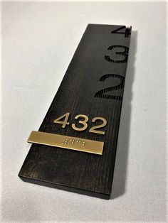 a wooden sign with the number 432 on it's front and back sides