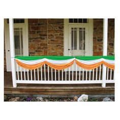 an orange and white curtain is hanging on the front porch