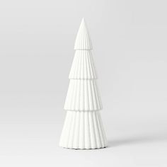 a white ceramic christmas tree on a white background