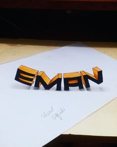 the word emfn spelled out in black and yellow letters on top of a piece of paper