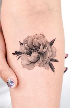 a woman's arm with a flower tattoo on the left side of her body