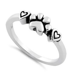 a white gold ring with three hearts and the word love written in black on it