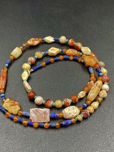 The beautiful old carnelian beads necklace from Ancient Greco-Bactrian times very rare beads from collections very rich in patina patina means in simple words rust as you can see white patina on almost every beads. this is because of this beads are undergrounded for long period of time and get this patina from ground , with the help of this patina you can see very easy authenticity of this beads as well The origin of this beads are from Afghanistan The age of Bactrian Bead are circa 256 to 125 B Vintage Amber Beads, Gems, And Cabochons, Vintage Natural Stone Beaded Necklaces, Vintage Agate Beaded Necklace With Colorful Beads, Vintage Amber Beaded Gems And Cabochons, Vintage Handmade Agate Beads, Gems, And Cabochons, Vintage Natural Stone Beads For Jewelry Making, Handmade Vintage Agate Beads, Gems, And Cabochons, Vintage Natural Stones Beads For Jewelry Making, Handmade Vintage Agate Beads