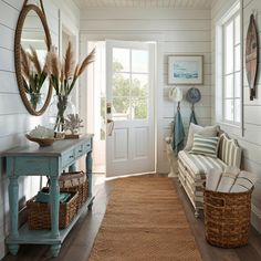 a living room filled with furniture next to a white door and wooden floored walls