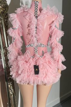 a mannequin is dressed in pink with sequins on it's bust