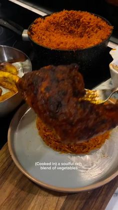 a plate with some food on it next to other bowls and pans filled with food