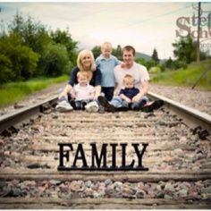 a family sitting on train tracks with the word family over them