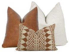 two brown and white pillows sitting next to each other